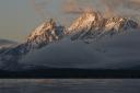The first rays of daylight hit the Grand Teton